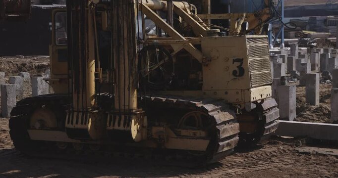 Pile driving machine moving on construction site