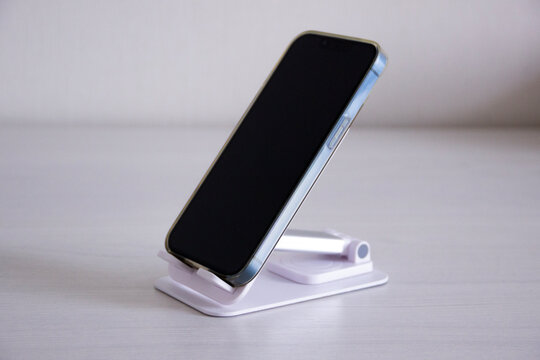 smartphone on a blastic adjustable stand on a table