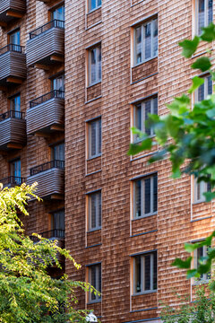 Urban architecture exterior featuring brick facade windows and modern pattern on apartments building with textured surface and clean design