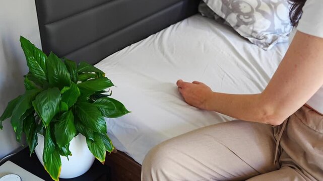 Replacing regular pillow with ergonomic orthopedic pillow on bed. Improving cervical spine support and neck alignment for better sleep, posture correction and pain relief at home.