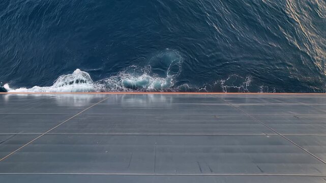 Serenity of Ocean Waves Crashing Against Ship Deck in Dark Blue Waters