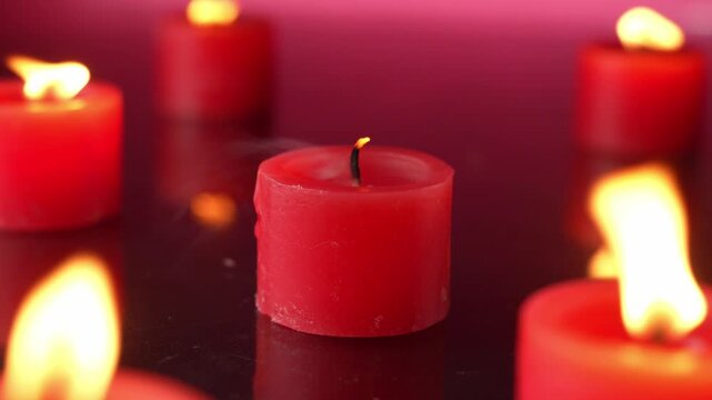 Red small Candles shown In A Dark red Room