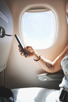 Hands, phone and woman in plane for travel, boarding pass or check flight details. Transport, airplane mode and passenger with mobile in cabin for global journey, airline app or digital ticket