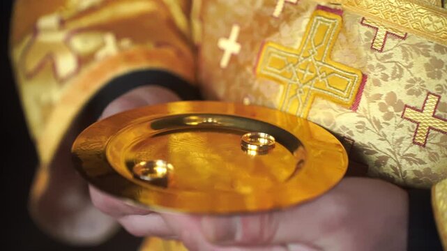 A church minister puts wedding rings on the newlyweds. Wedding in an Orthodox church