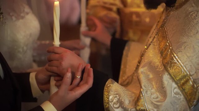 A church minister puts wedding rings on the newlyweds. Wedding in an Orthodox church