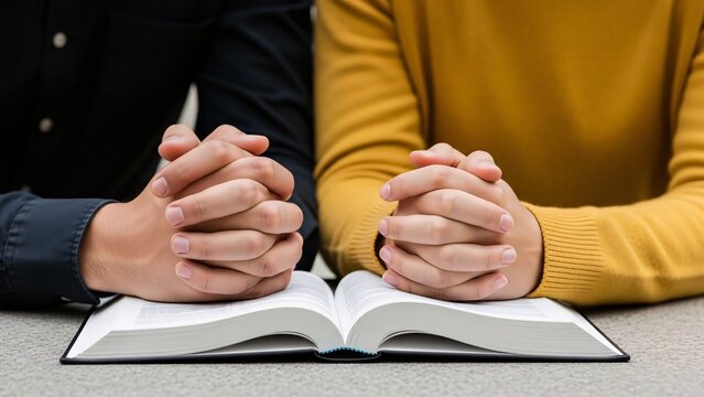 Couple praying together with open bible