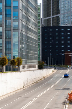 Urban Paris La Defense street road with empty curve leading toward office skyscraper architecture creating a clean modern route through the district