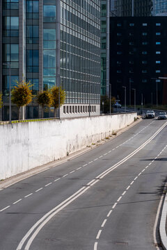 Perspective view of empty street road in Paris La Defense showing urban office skyscraper architecture and calm city rhythm under soft daylight
