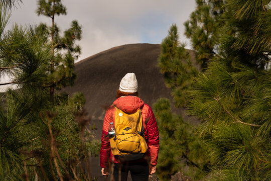 Hiker with backpack explores Chinyero volcano in Tenerife forest