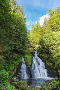 Man cheering on bridge at Triberg Waterfall in Black Forest Germany