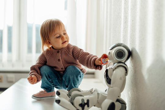 Child interacting with robot in medical setting emphasizing AI trust