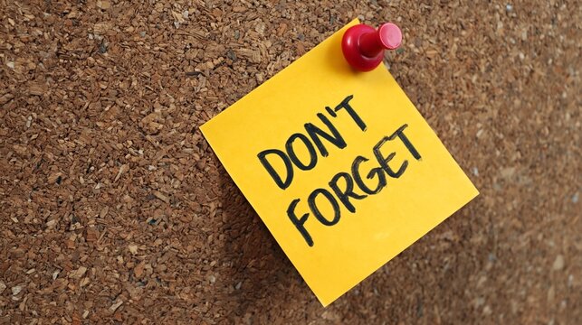 Don't forget reminder text on yellow sticky note pinned to corkboard