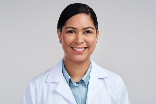 Portrait, scientist and woman with smile in studio, professional and confident for medical innovation. Happy, healthcare and lab technician with pride for research study, science and white background