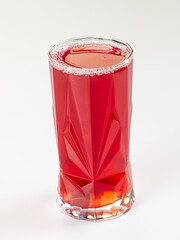 Vibrant red berry drink in a faceted glass tumbler, isolated on a clean white background. © Andrei Starostin