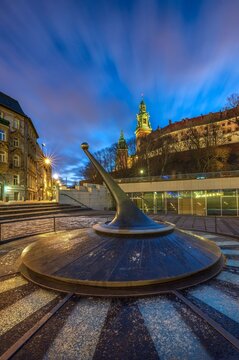 Modern sundial with Wawel Royal Castle at blue hour, Krakow, Poland