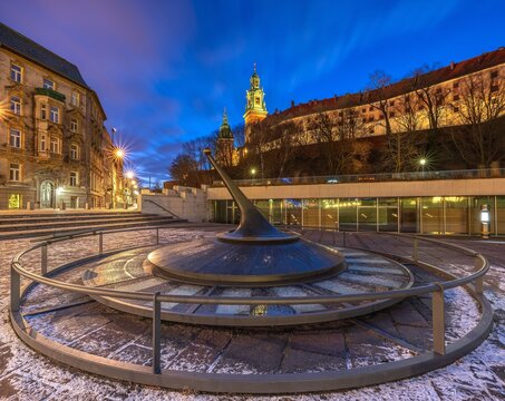 Modern sundial with Wawel Royal Castle at blue hour, Krakow, Poland