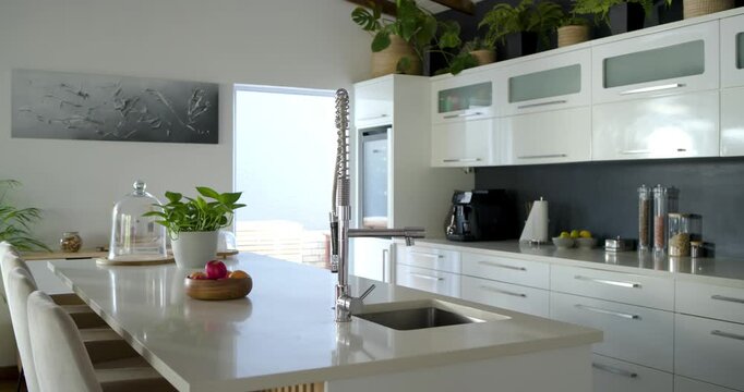 Camera is pulling back, stainless-steel pull-down spring faucet is anchoring kitchen island reveal