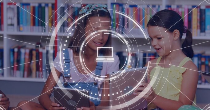 Two girls sitting on library floor tapping tablets and causing AR HUD overlay highlighting books
