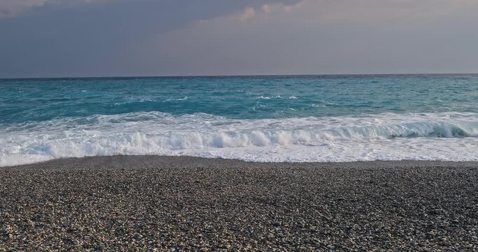 The azure Pacific Ocean washes against the gravel beaches of Qixingtan Beach in Hualien, Taiwan.