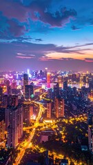Obraz premium A breathtaking aerial view captures a vibrant cityscape illuminated by dazzling lights against a stunning twilight sky, showcasing the modern architecture and bustling energy of an urban center.