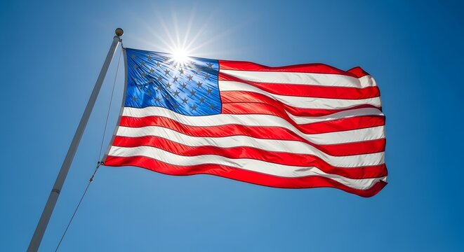 American flag waves proudly against a bright blue sky with sunburst.