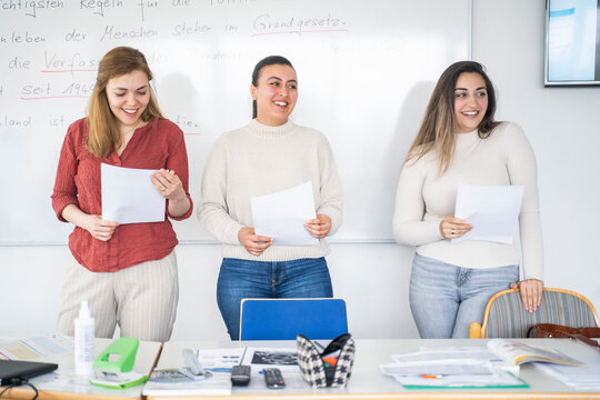Students presenting a project in a multicultural classroom setting