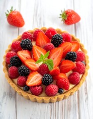 Obraz premium Close-up of a fruit tart on a rustic white wooden surface, featuring berries and mint garnish