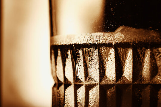 Close up of condensation on glass with abstract warm light