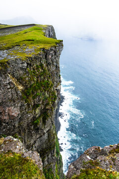 Aerial view from the cliff at Eidiskollur down to the blue atlantic ocean, Faroe Islands