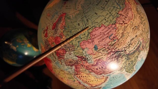 Pointer indicating western Russia on world map.