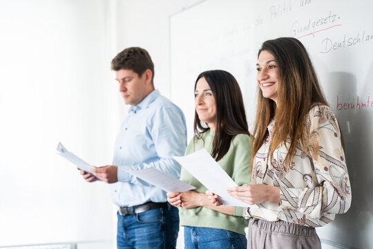students of different nationalities, in front of the blackboard