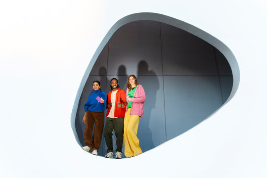 Gen Z friends talking and posing in modern architecture
