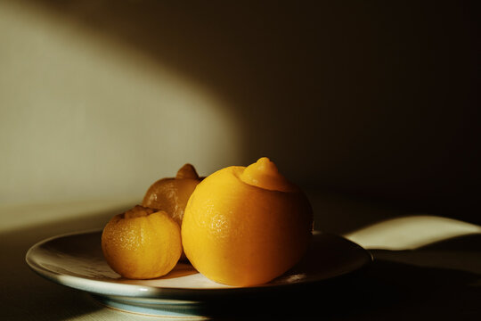 Preserved lemon on dish in dramatic shadow and light
