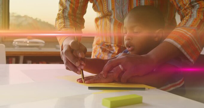 Animation of light flashing over african american father and son drawing hand on paper