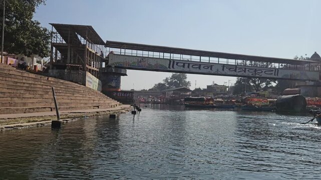 Scenic view from a moving boat at Ram Ghat in Chitrakoot, Madhya Pradesh, on the sacred Mandakini River. This spiritual riverside location is associated with Lord Rama, Sita, and Lakshman.