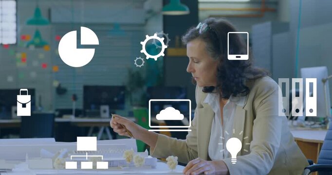 Animation of multiple digital icons against man working on his plan at office