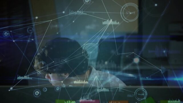 Male analyst scanning behind monitor, reacting to network HUD alert, leaning, speaking into handset