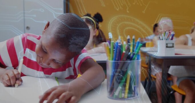 Boy wearing striped tee writing classwork, camera panning revealing pencil cup and circuit overlay