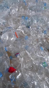 Crushed plastic bottles pile showing environmental damage and waste crisis