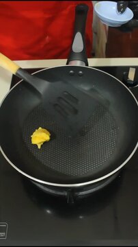 Chef Melting Fresh Yellow Butter in a Professional Frying Pan