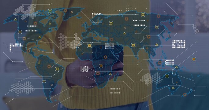 Presenting woman in ribbed mustard sweater showing world map overlay at demo with hex grid icons