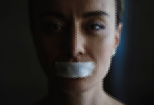 Portrait with tape on mouth symbolizing censorship and silence