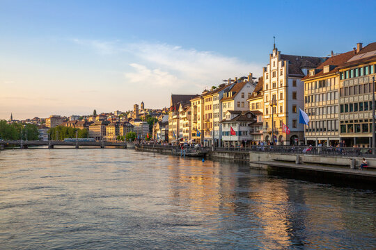 Zurich Limmatquai waterfront at sunset with historic buildings in summer