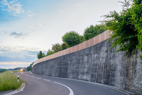 Solar fence along curved road for renewable energy in Schmerikon Switzerland