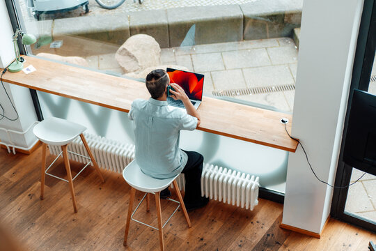 Self-employed developer working at modern office window workspace