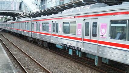 South Tangerang, Indonesia - April 5, 2026: An electric train stopped at the station, an Electric Multiple Unit (EMU) train of the JR 205 series operated by KAI Commuter in Indonesia.