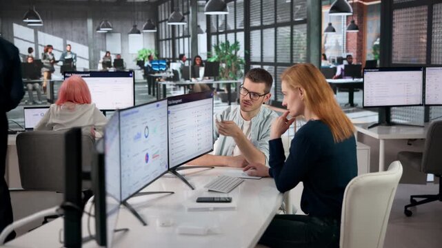 Risk Manager Analyzing Enterprise Strategy Using Multiple Computer Screens