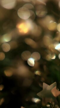 Bokeh Christmas decor, tinsel close up, shiny sparkling light, colored tree decor, blurry atmosphere