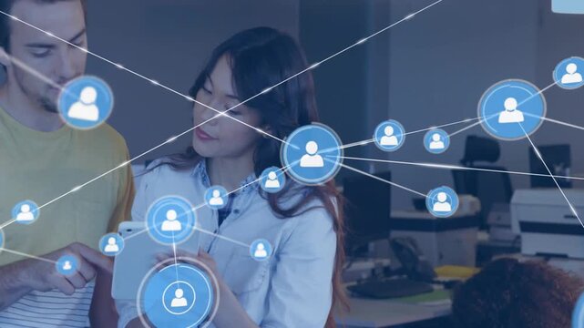 Notepad scribbling starting blue network appearing, standing pair examining tablet, showing links