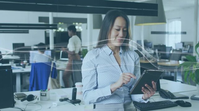 Woman tapping tablet and adjusting mic, preparing office call while animated wave moving over shot